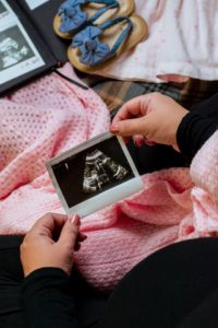 couple looking at sonogram after struggling with infertility