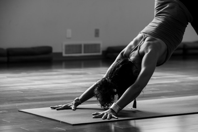 A black and white images of a woman stretching on a yoga mat. Brookfield prenatal chiropractor Prenatal chiropractor Brookfield pediatric chiropractor
