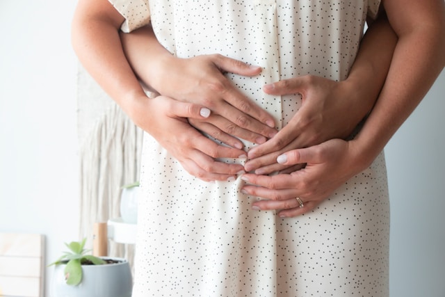 A man and a woman embracing a pregnant belly. Brookfield prenatal chiropractor Prenatal chiropractor Brookfield pediatric chiropractor