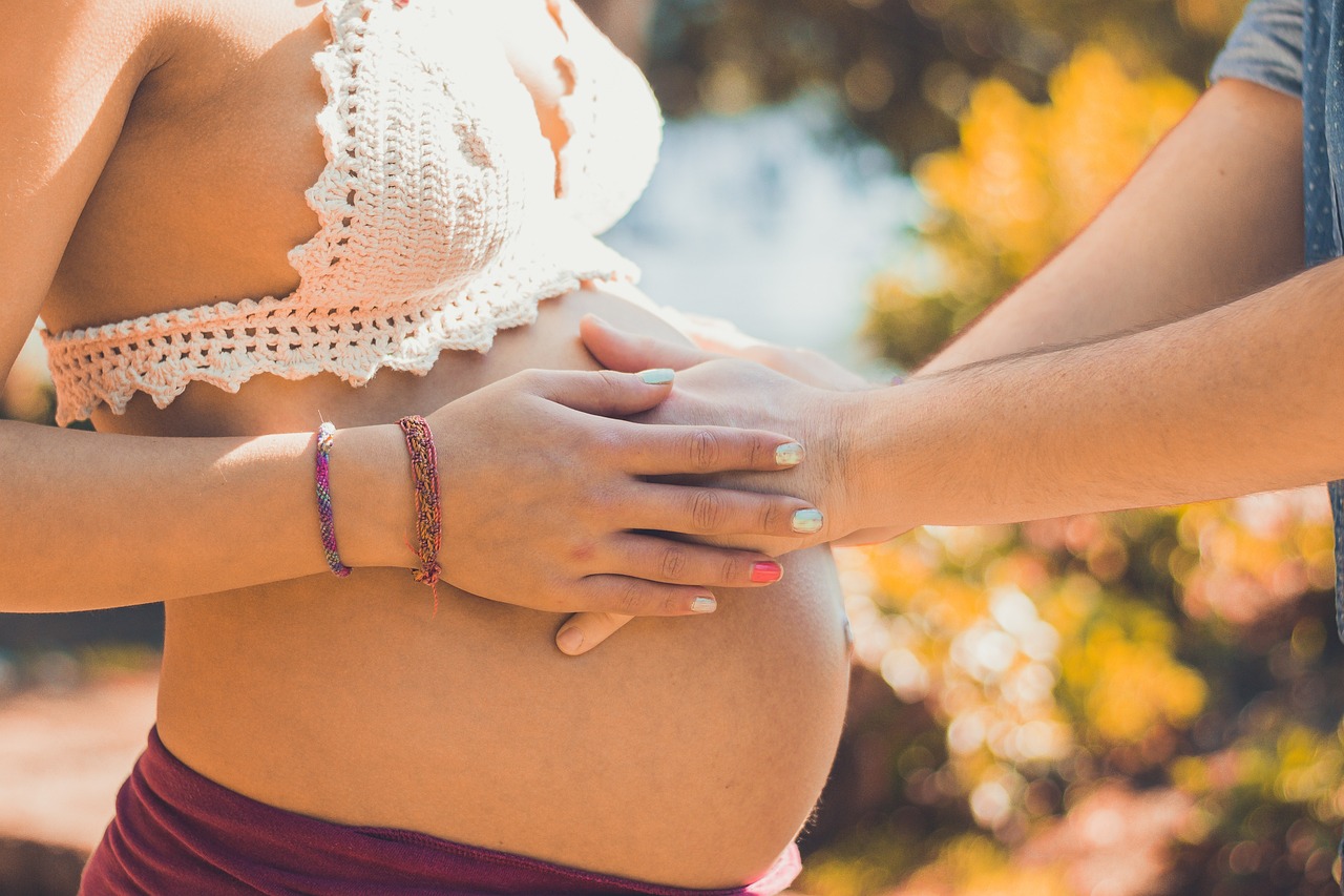 Pregnant woman touching belly