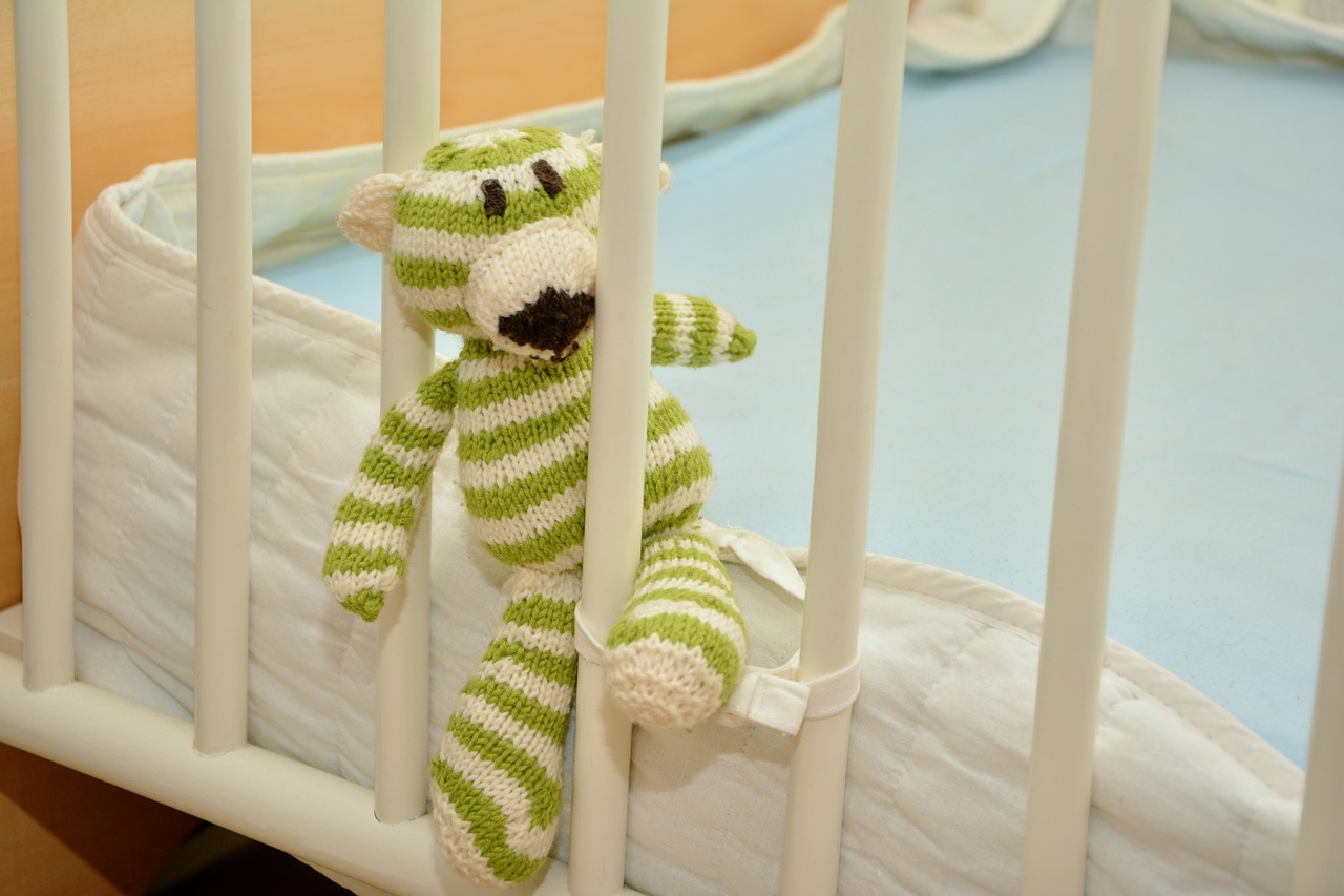 Photo of a striped tiger baby toy in a crib