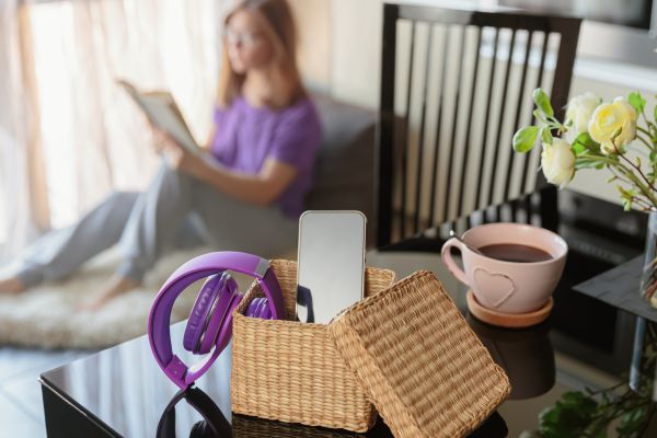 Photo of a woman digital detoxing with a book and tea
