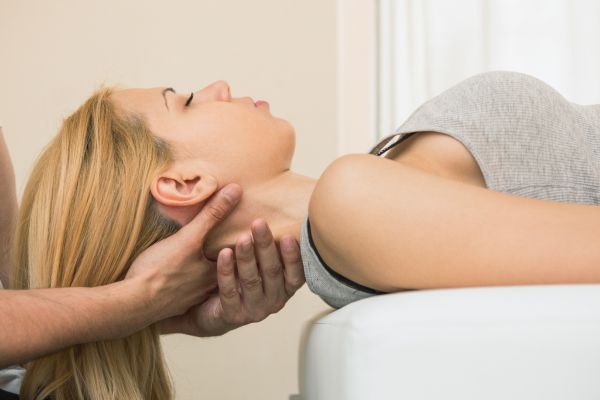 Woman having a chiropractic adjustment which may improve spine help and foster fertility