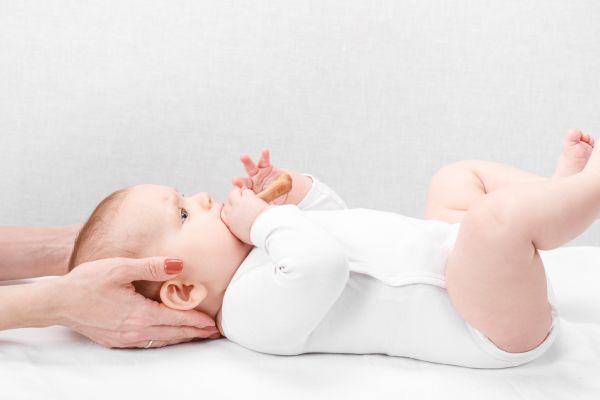 Baby laying on his back being adjusted by a prenatal chiropractor
